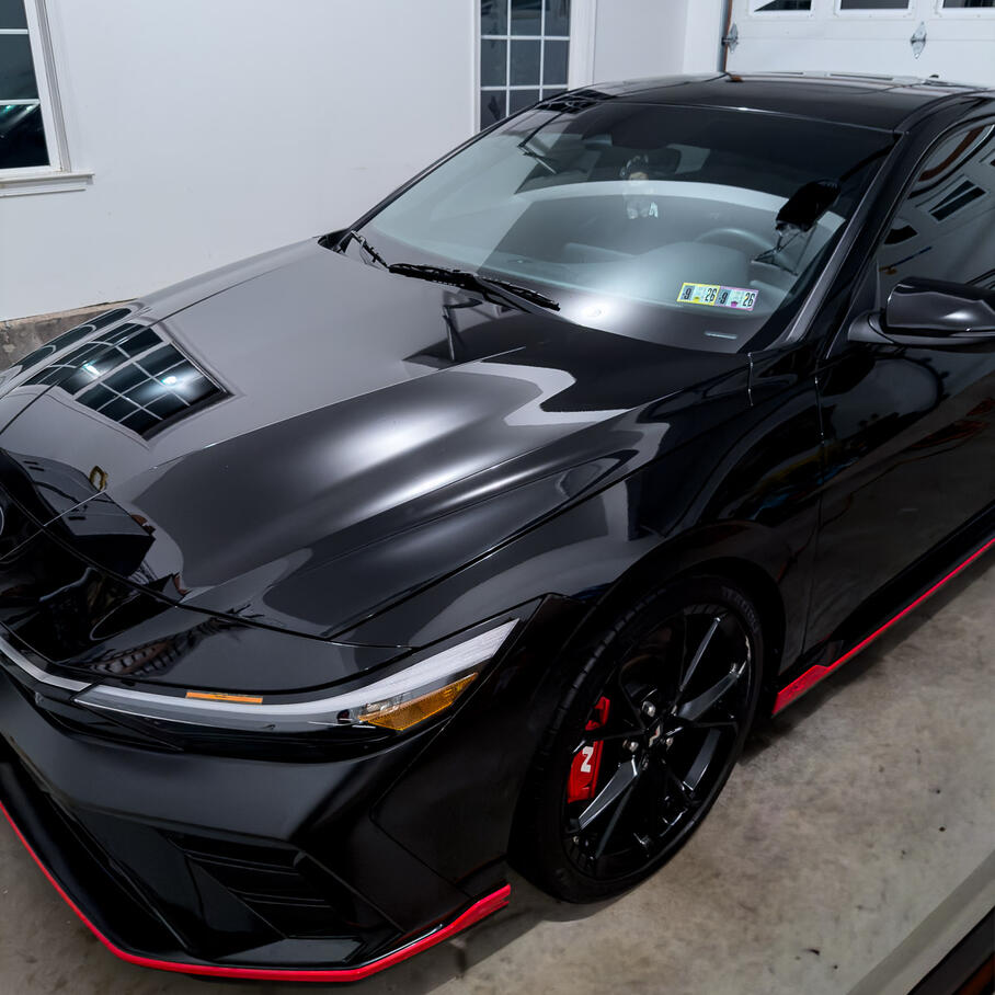 Glossy black car paint finish after a thorough clay mitt and wax protection service in Limerick PA