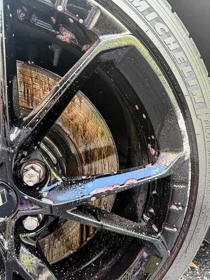 Iron remover bleeding purple while dissolving brake dust during a wheel detailing service in Royersford PA.