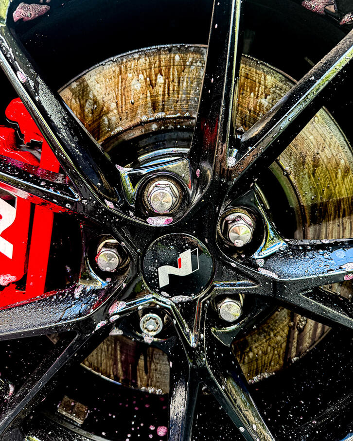 Iron buster decontamination spray actively bleeding purple on a sports car wheel barrel in Pottstown PA.