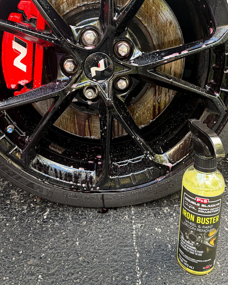 Close-up shot of professional wheel cleaning spray lifting metallic fallout at a mobile detail job in Spring City PA.